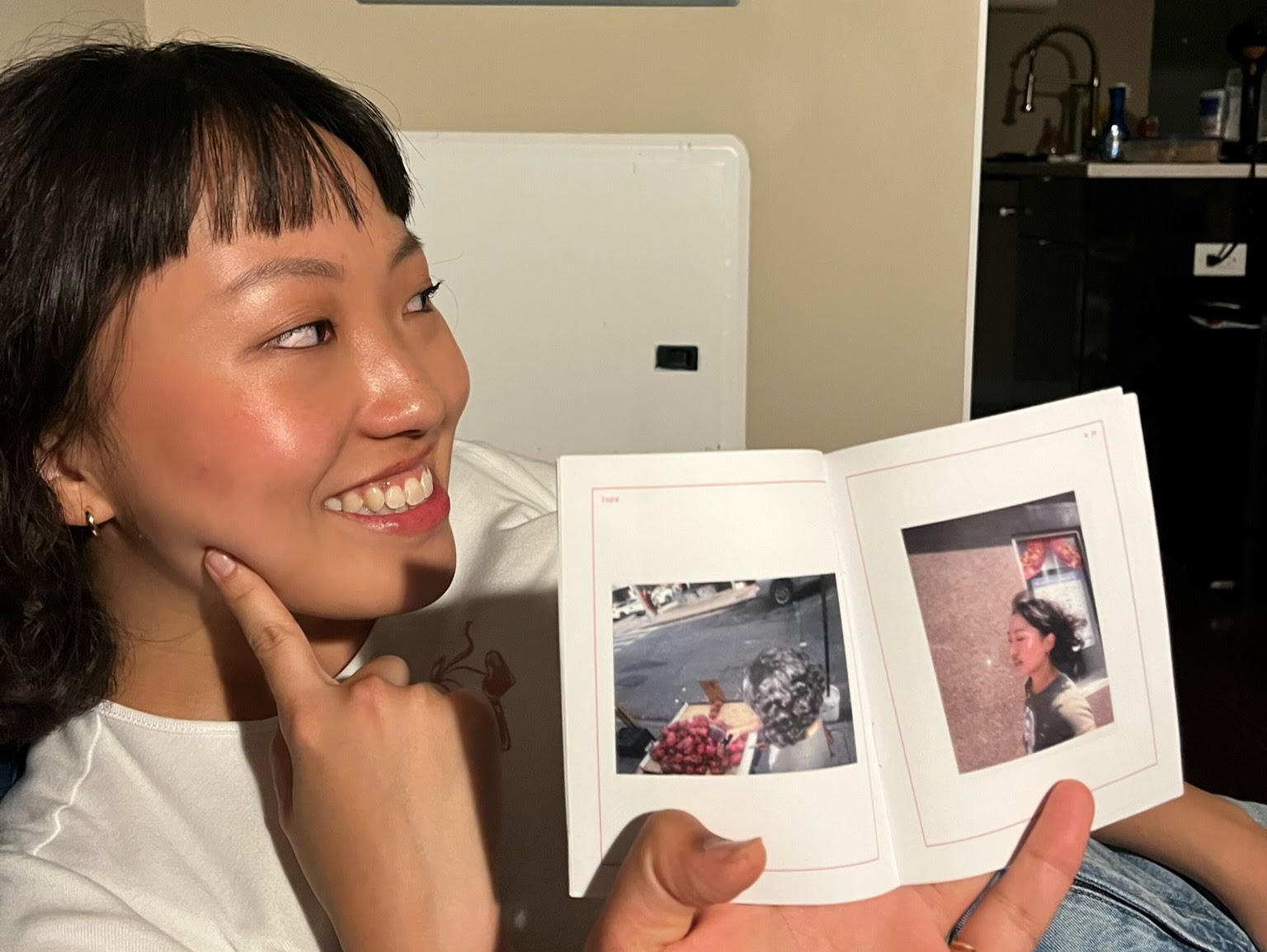 Ginny poses next to Ginny spread from tops zine